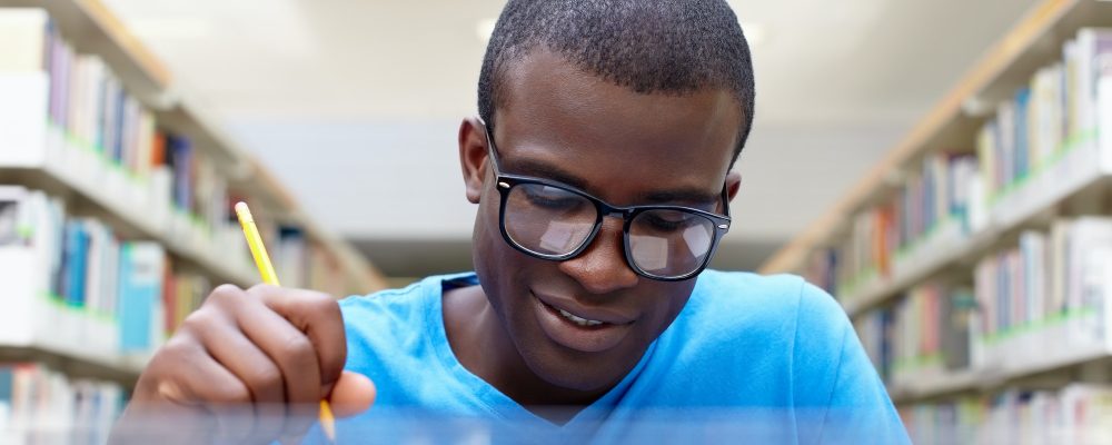 Young African Man Studying In Library Young African Man Studying In Library